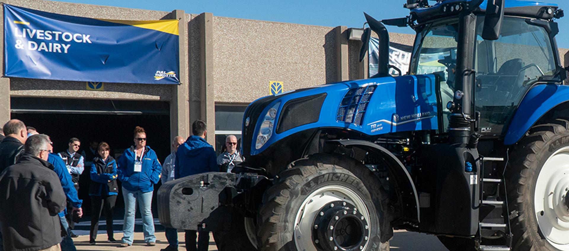 employees outside of event with new heavy machinery