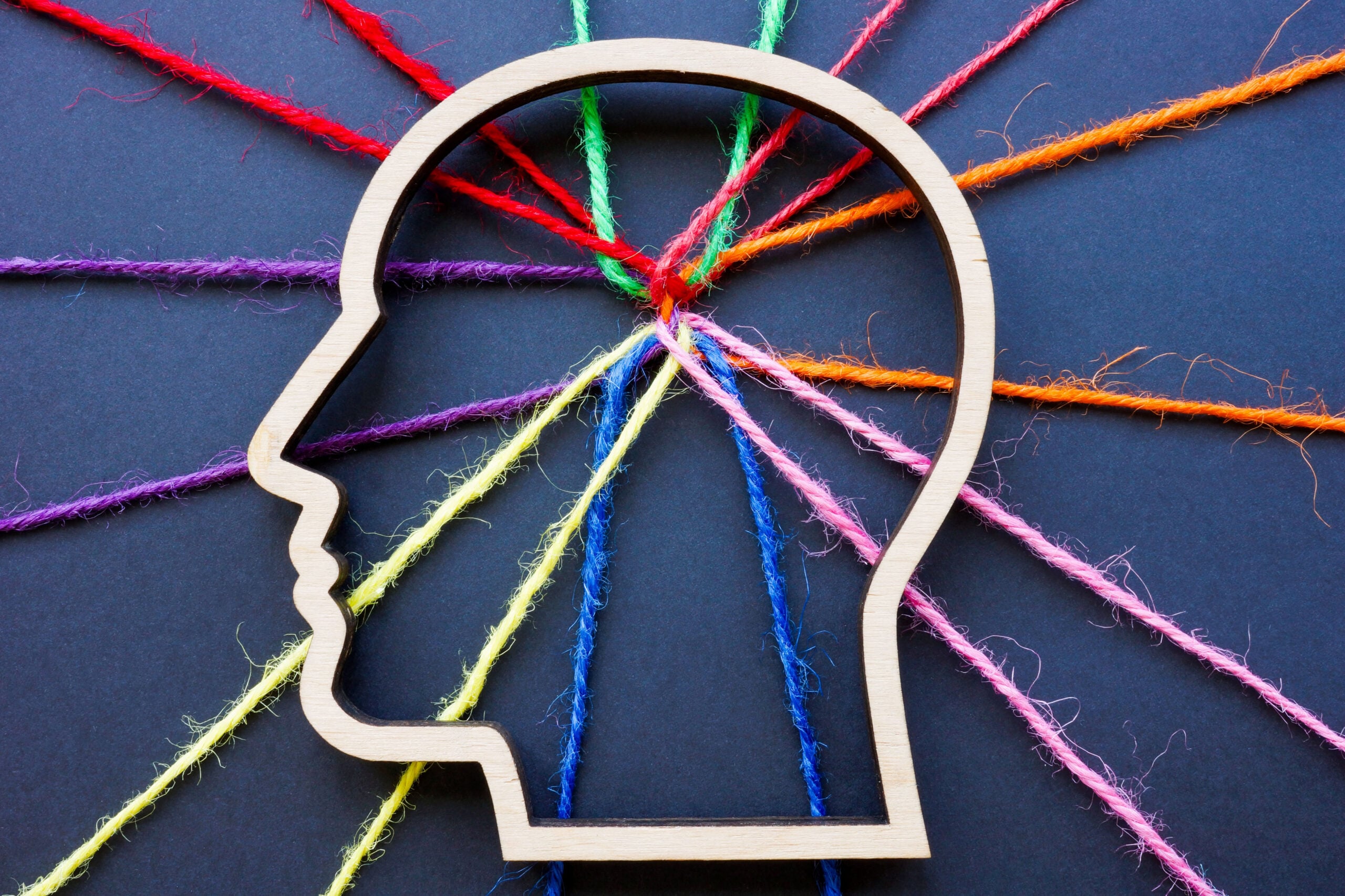 The outline of head and connected colored threads