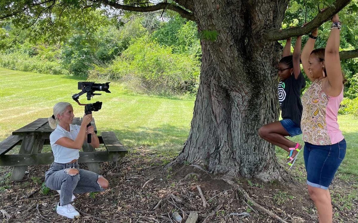 people taking a picture of a tree