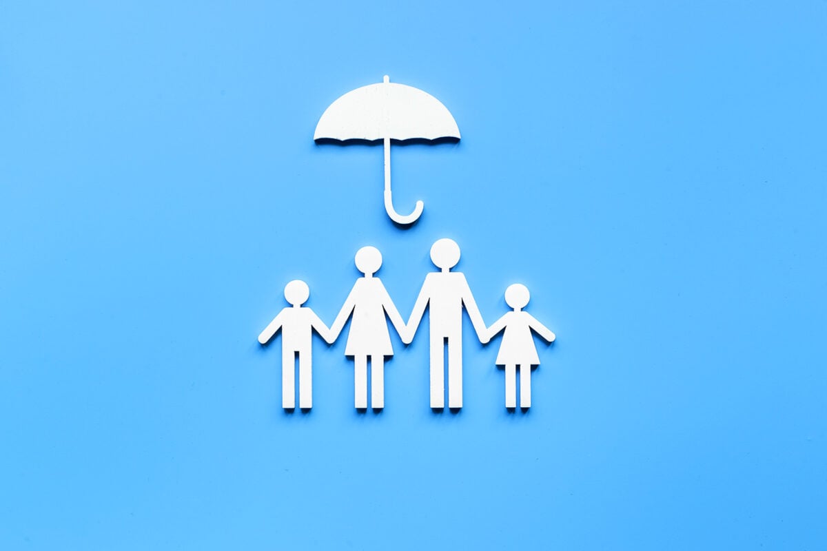 Concept of an umbrella protecting a family like insurance; liability