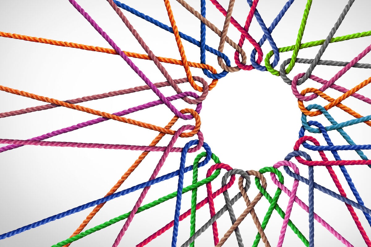 Business Unity and connection partnership as ropes shaped as a circle in a group of diverse strings connected together shaped as a support symbol expressing the feeling of teamwork and togetherness.