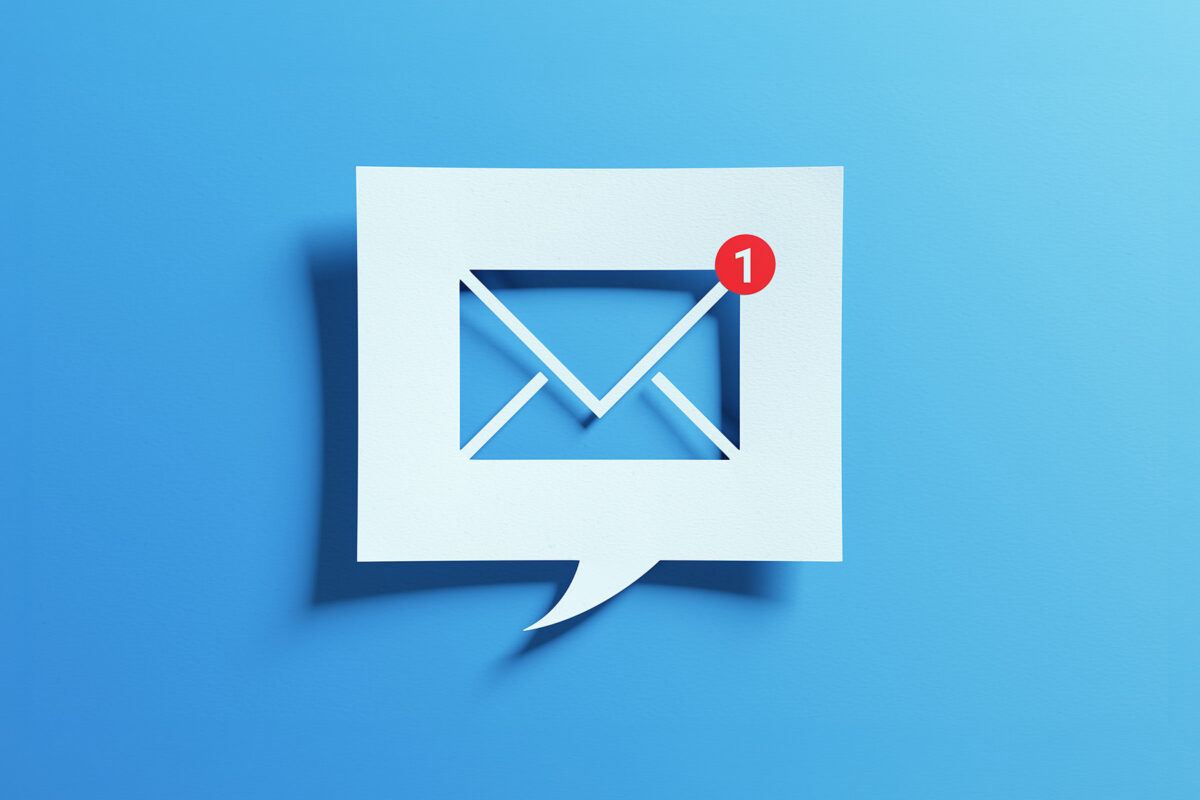 communication and digital marketing. Inbox receiving electronic message alert. Abstract minimalist design with cutout paper and blue background.