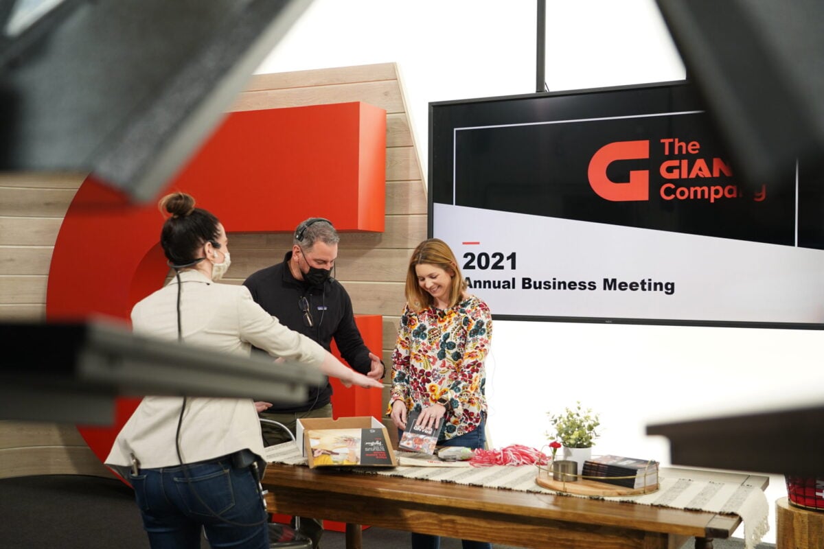 a group of people standing around a table