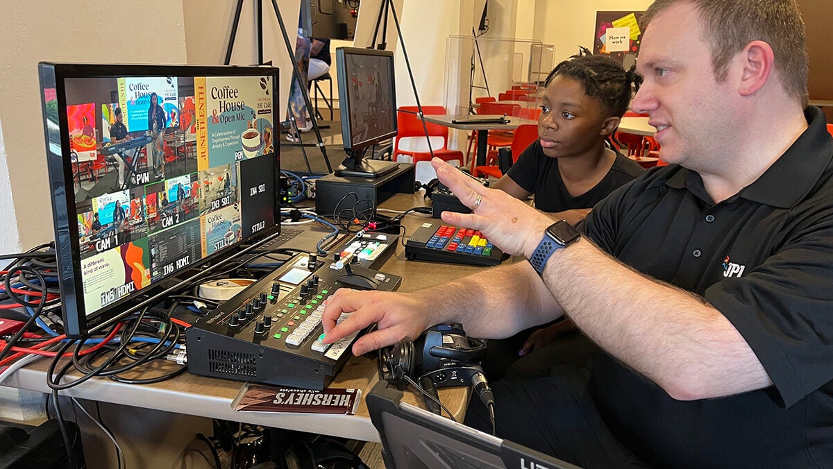 JPL intern and employee looking at a screen