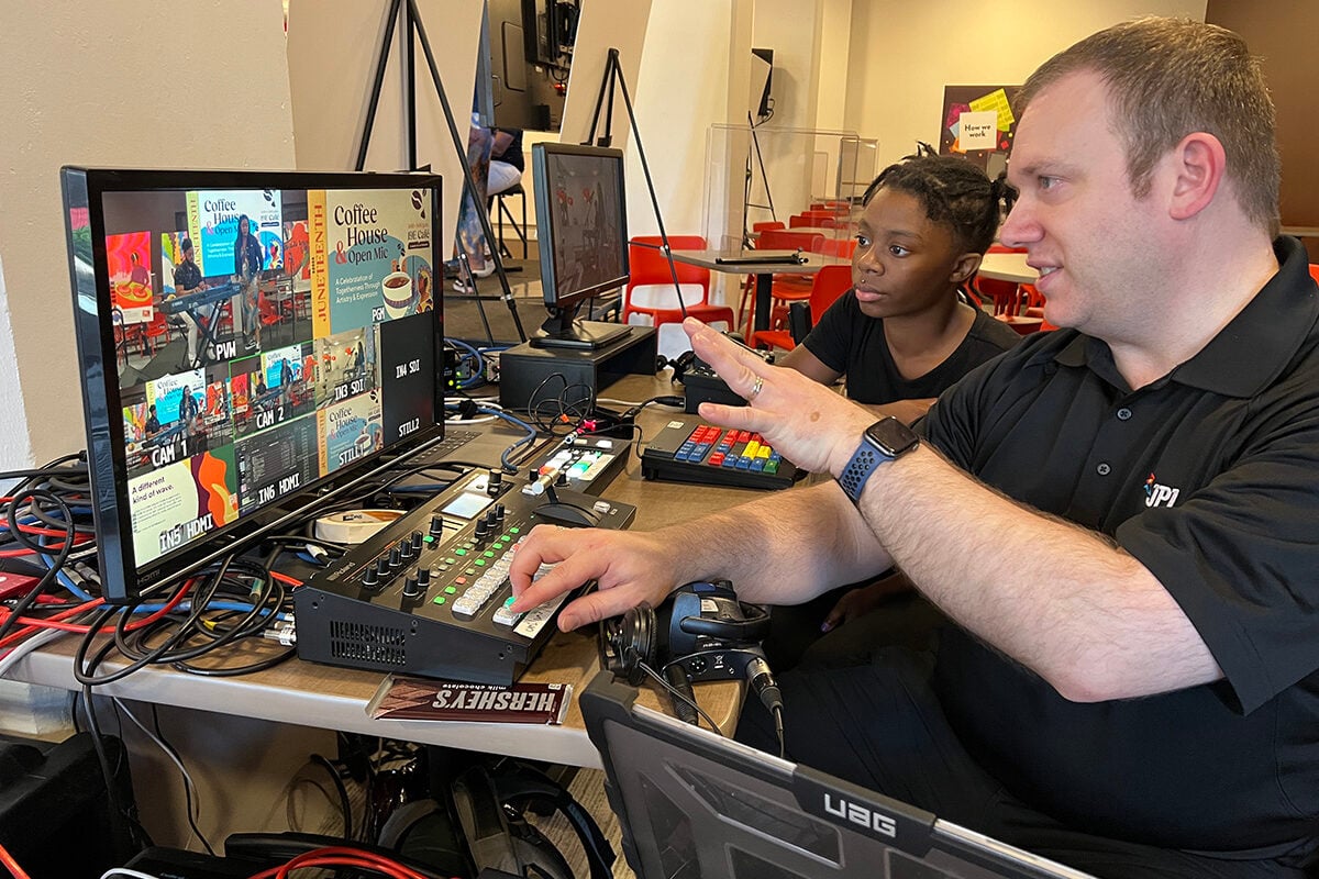 JPL intern and employee looking at a screen