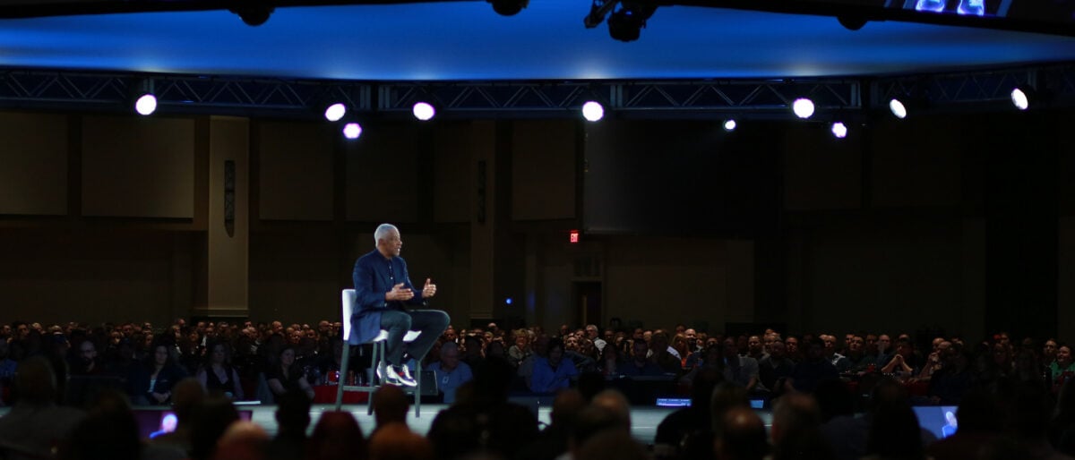 a person sitting in a chair in front of a crowd