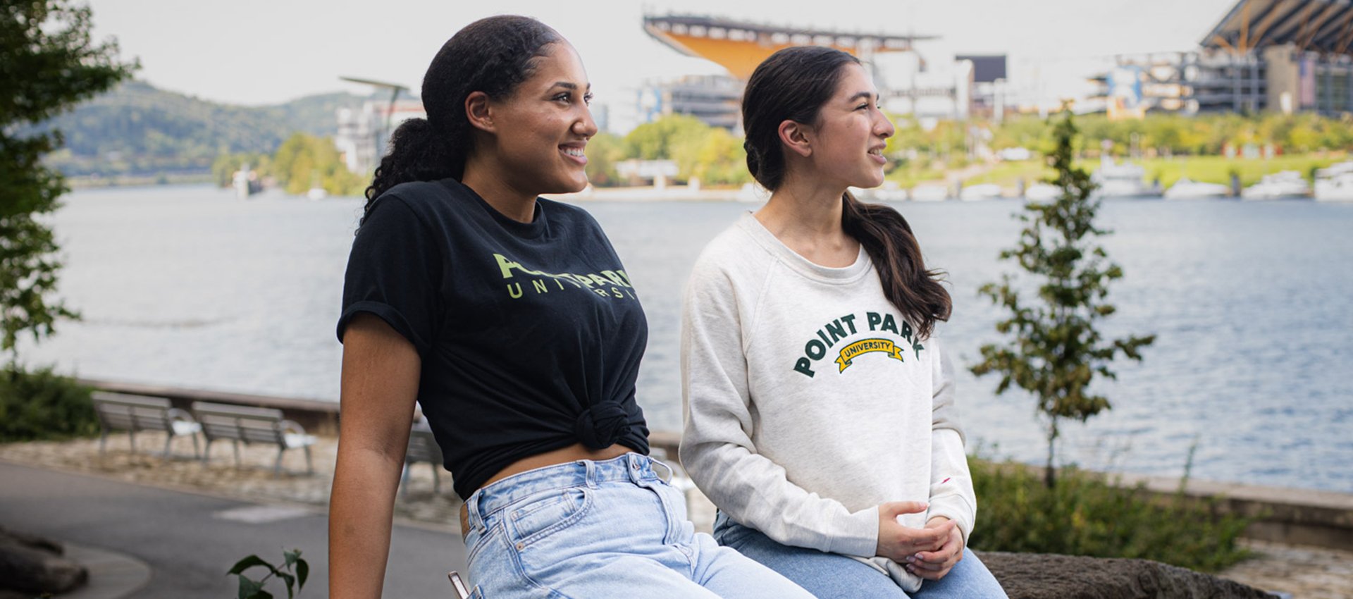 two women sitting on a bench