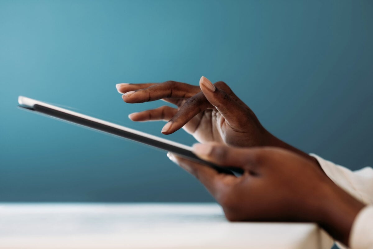 Hands touching an iPad.