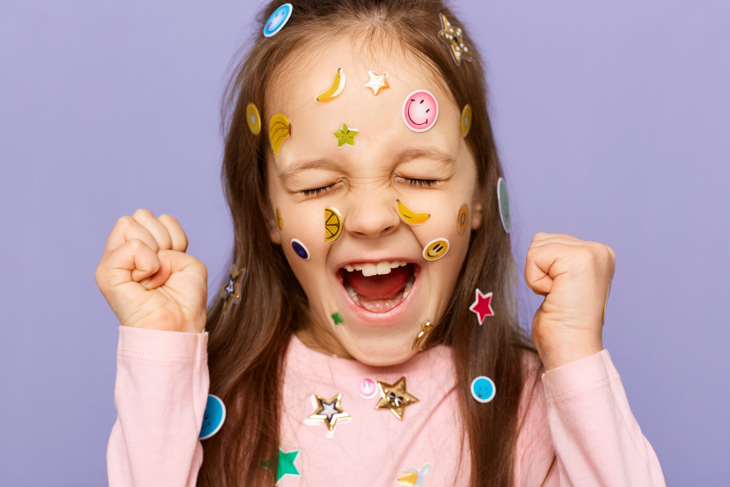 Happy, young girl covered in stickers