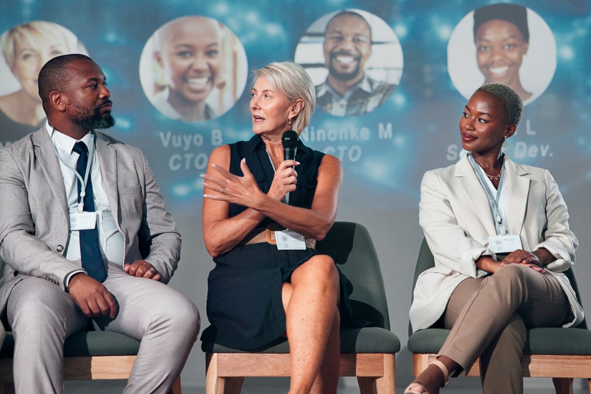 Business people, speaker and panel for audience, presentation and seminar for start up conference or convention. Woman, microphone and question for international trade show, event or workshop