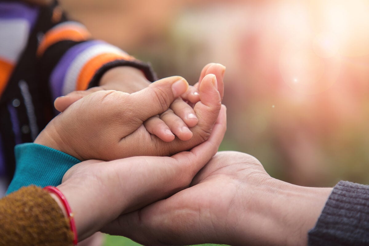 Father's mother's and baby's hand