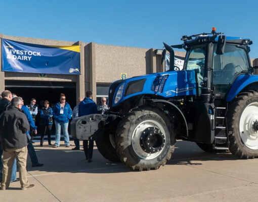 New holland tractor with people around it