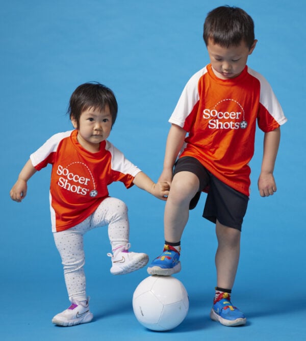 two kids in soccershots uniform