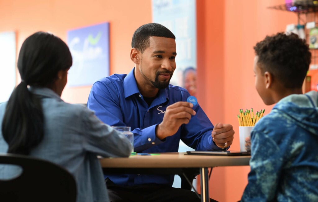 male sylvan instructor teaching two students