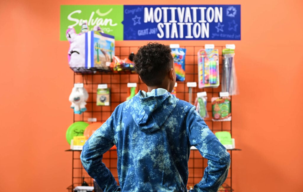 young male sylvan student looking at the motivation station